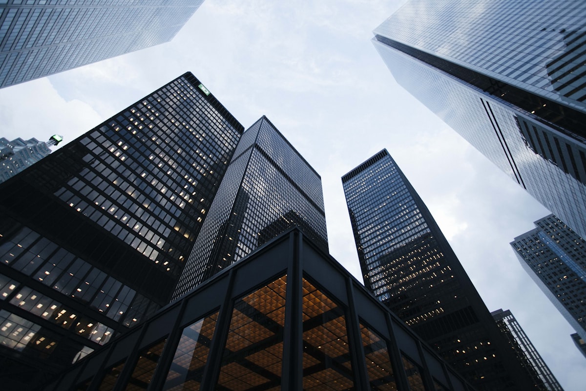 Modern corporate skyscraper building reflecting blue clouds representing strength and reliability
